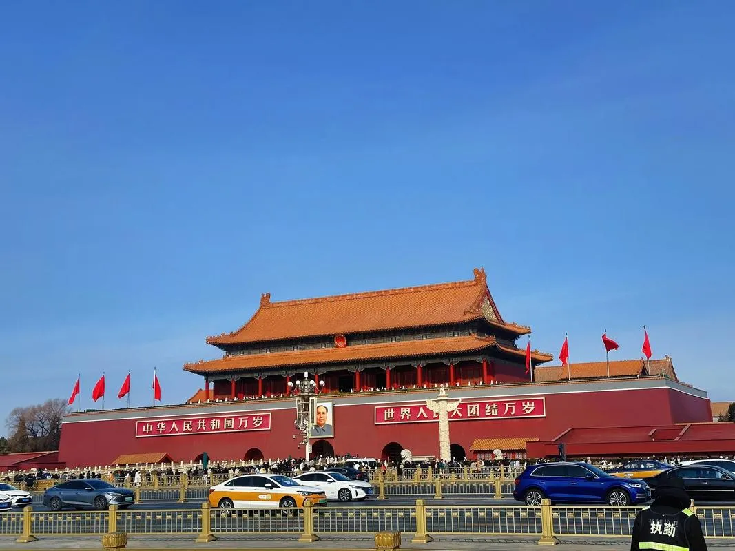 Ancient wooden temple architecture and courtyard lanes under clear blue skies in Beijing.