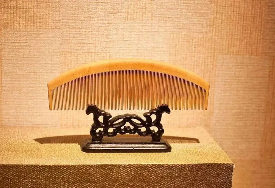 A wooden comb resting on a table, used as a visual reference for Changzhou comb craft.