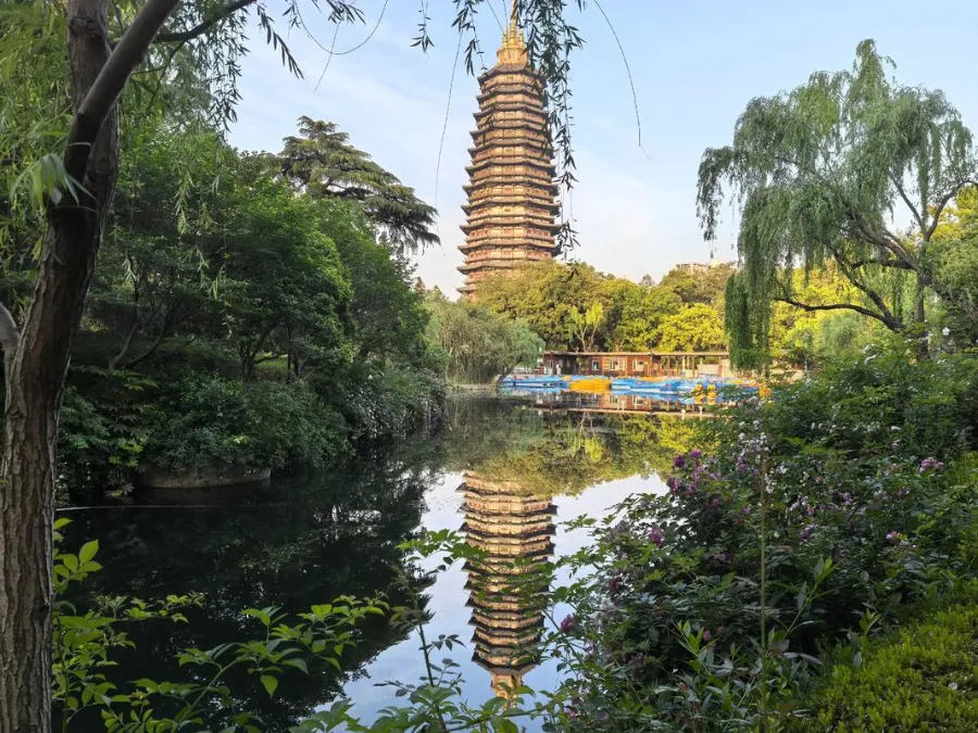 A lighted Buddhist pagoda at night, used as a visual reference for Tianning Pagoda.